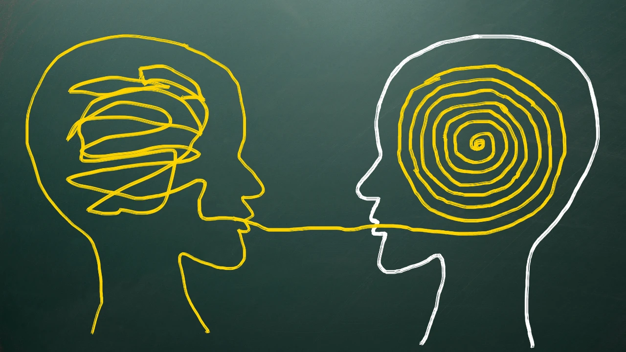 Dessin de deux têtes face à face qui démêlent les pensées pour comprendre la profondeur des émotions