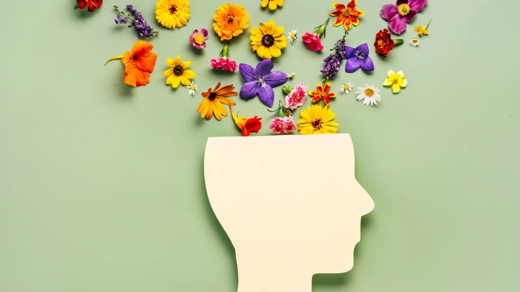 Tête avec des fleurs qui sort du haut du crâne, ce qui représente la santé mentale
